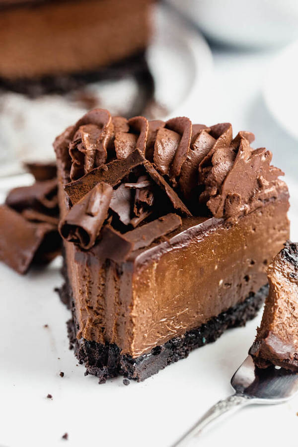 chocolate cheesecake baked in an Oreo crust topped with chocolate ganache, chocolate whipped cream, cocolate shards and a dust of cocoa powder.