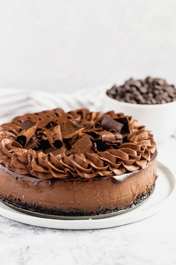 chocolate cheesecake baked in an Oreo crust topped with chocolate ganache, chocolate whipped cream, cocolate shards and a dust of cocoa powder.