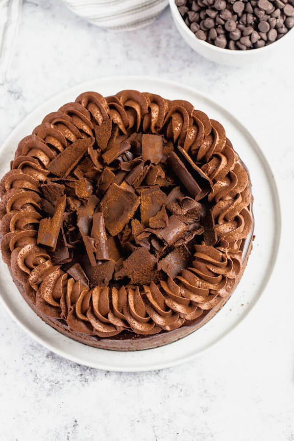 chocolate cheesecake baked in an Oreo crust topped with chocolate ganache, chocolate whipped cream, cocolate shards and a dust of cocoa powder.