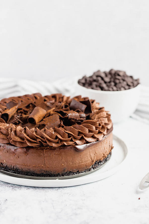 chocolate cheesecake baked in an Oreo crust topped with chocolate ganache, chocolate whipped cream, cocolate shards and a dust of cocoa powder.