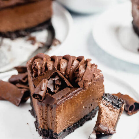 chocolate cheesecake baked in an Oreo crust topped with chocolate ganache, chocolate whipped cream, cocolate shards and a dust of cocoa powder.