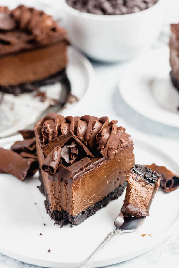 chocolate cheesecake baked in an Oreo crust topped with chocolate ganache, chocolate whipped cream, cocolate shards and a dust of cocoa powder.