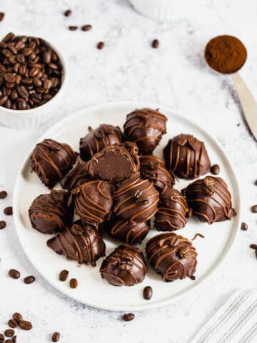 coffee ganache truffles coated in dark chocolate and drizzled with milk chocolate and whole coffee beans