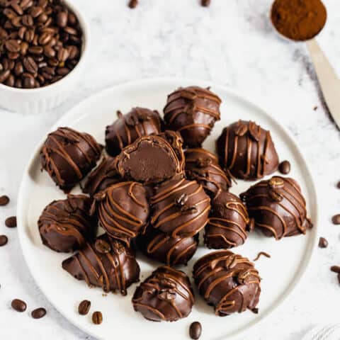 coffee ganache truffles coated in dark chocolate and drizzled with milk chocolate and whole coffee beans