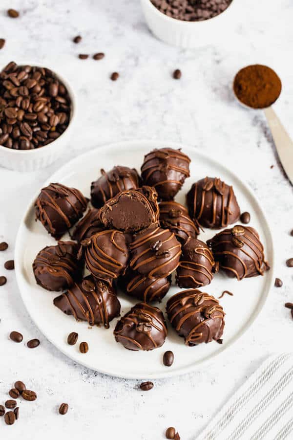 coffee ganache truffles coated in dark chocolate and drizzled with milk chocolate and whole coffee beans