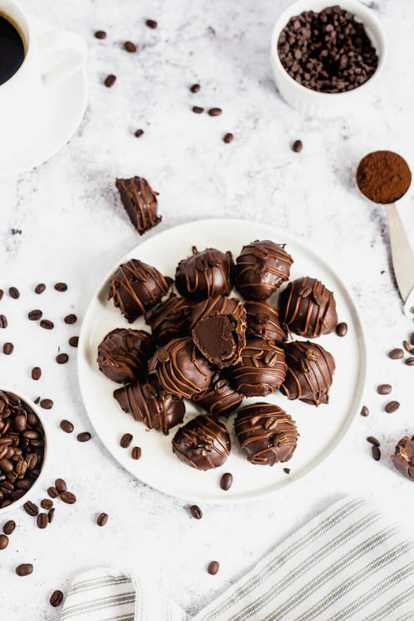 coffee ganache truffles coated in dark chocolate and drizzled with milk chocolate and whole coffee beans