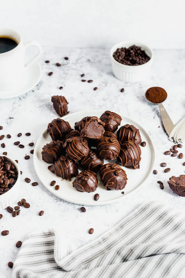 coffee ganache truffles coated in dark chocolate and drizzled with milk chocolate and whole coffee beans