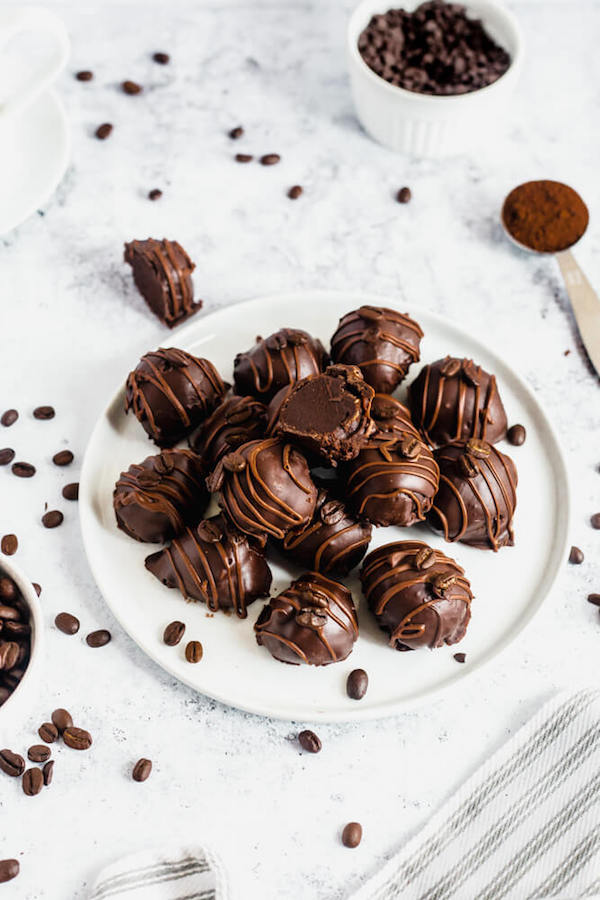 coffee ganache truffles coated in dark chocolate and drizzled with milk chocolate and whole coffee beans