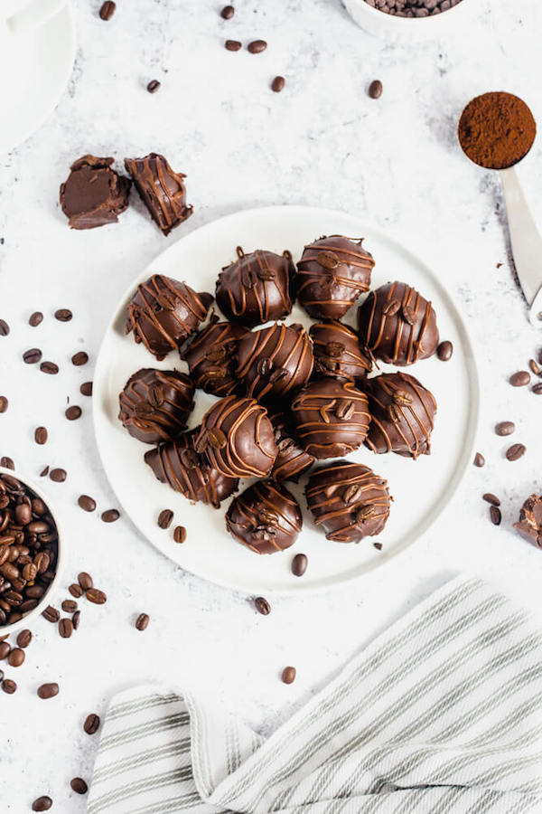 coffee ganache truffles coated in dark chocolate and drizzled with milk chocolate and whole coffee beans