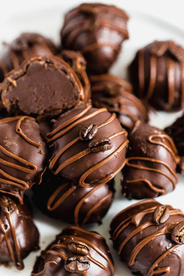 coffee ganache truffles coated in dark chocolate and drizzled with milk chocolate and whole coffee beans