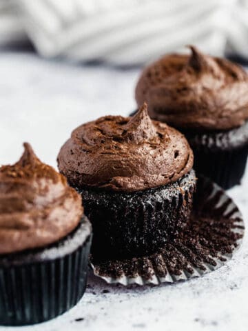 dark chocolate cupcakes topped with dark chocolate ganache frosting
