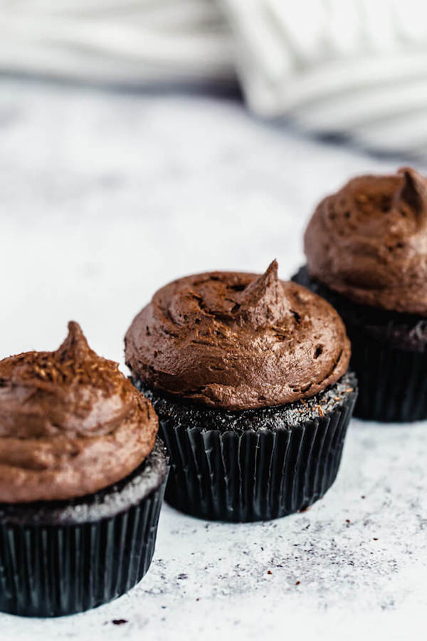 dark chocolate cupcakes topped with dark chocolate ganache frosting