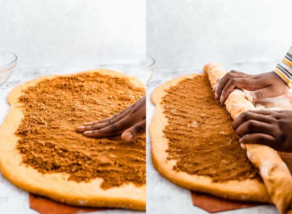 patting down brown sugar filling and rolling pumpkin cinnamon rolls