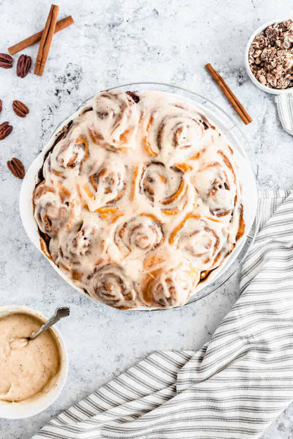 pumpkin cinnamon rolls topped with browned butter cream cheese icing