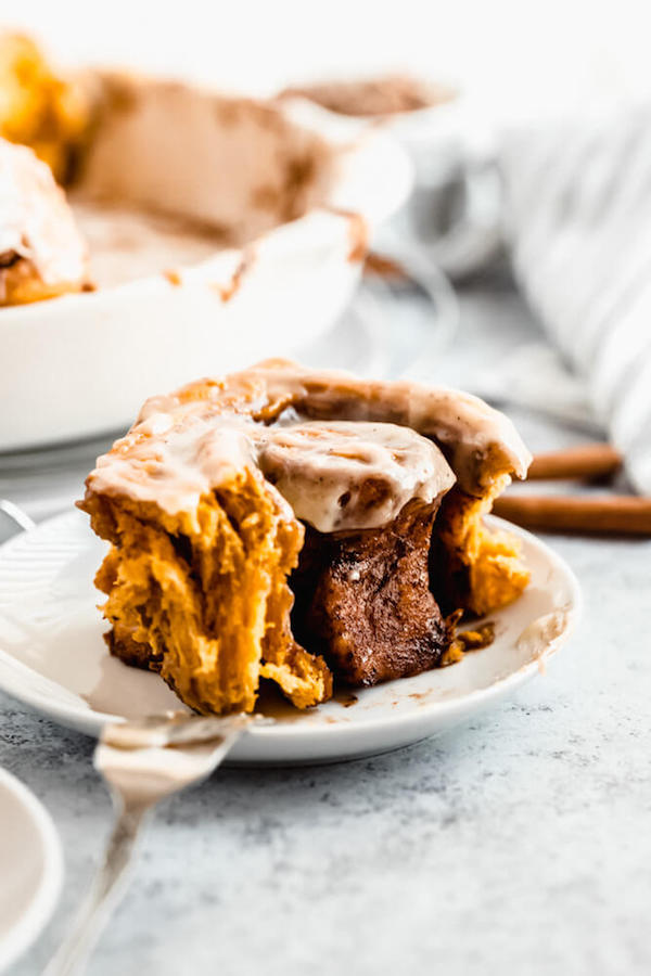 pumpkin cinnamon rolls topped with browned butter cream cheese icing