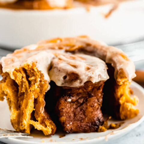pumpkin cinnamon rolls topped with browned butter cream cheese icing