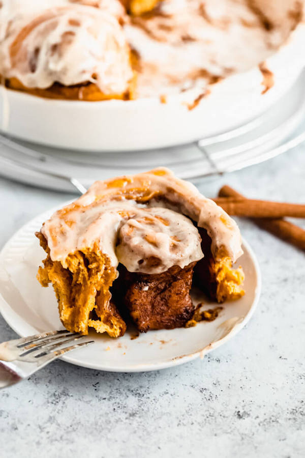 pumpkin cinnamon rolls topped with browned butter cream cheese icing