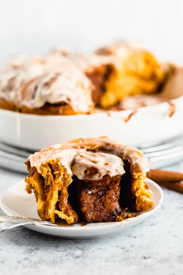 pumpkin cinnamon rolls topped with browned butter cream cheese icing