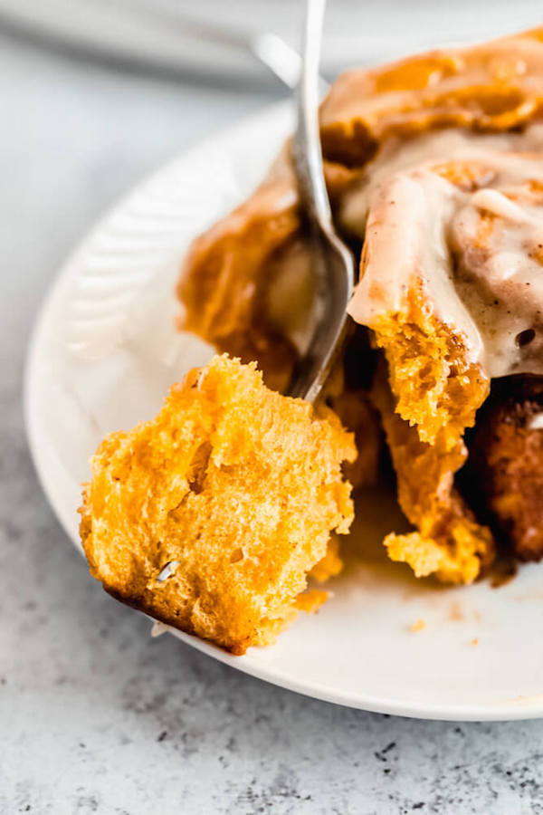 pumpkin cinnamon rolls topped with browned butter cream cheese icing