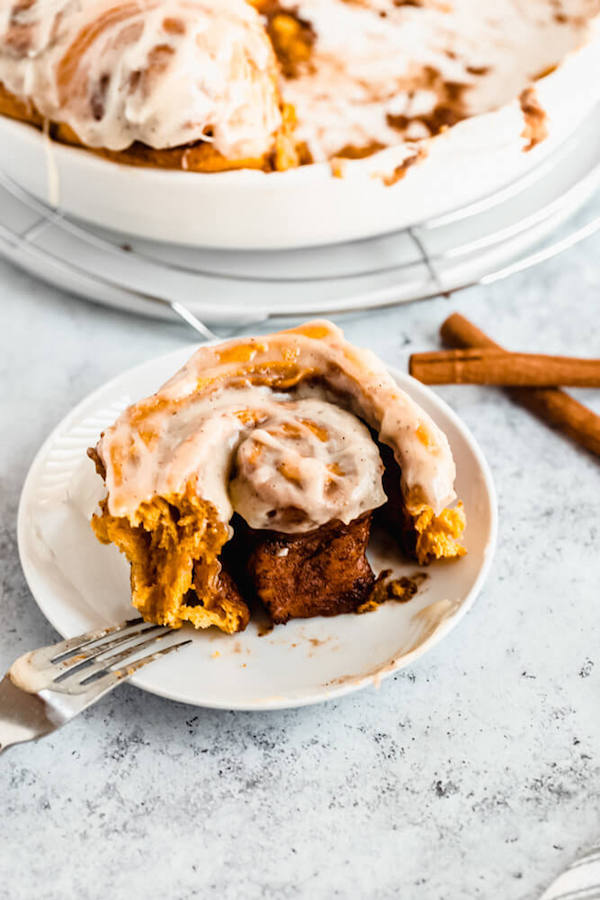 pumpkin cinnamon rolls topped with browned butter cream cheese icing