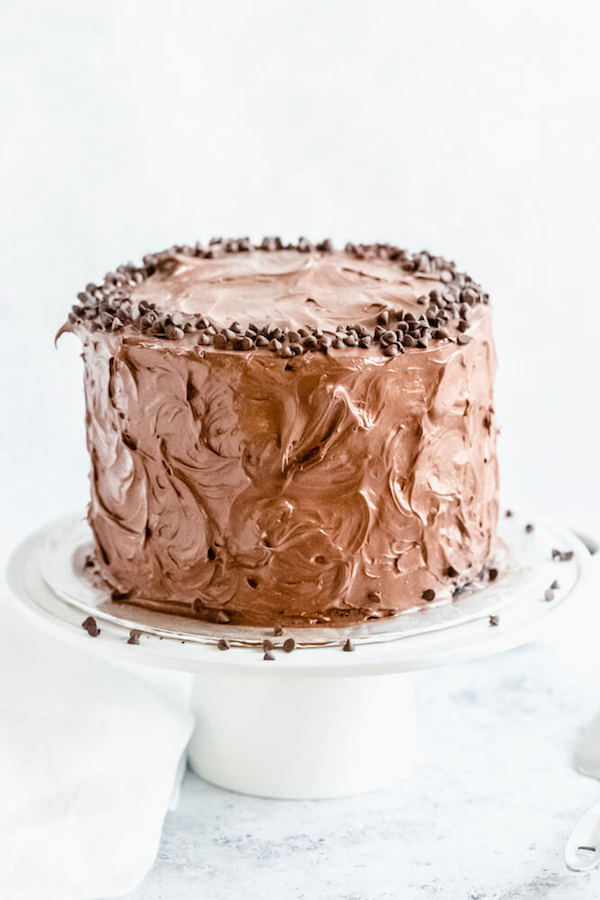 chocolate fudge cake on a cake stand