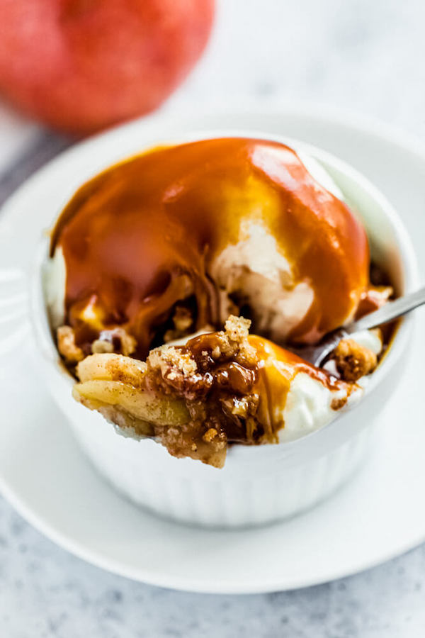 apple crisp topped with vanilla ice cream and salted caramel sauce