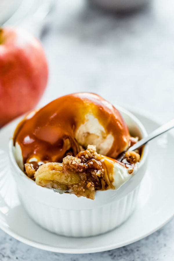 apple crisp topped with vanilla ice cream and salted caramel sauce