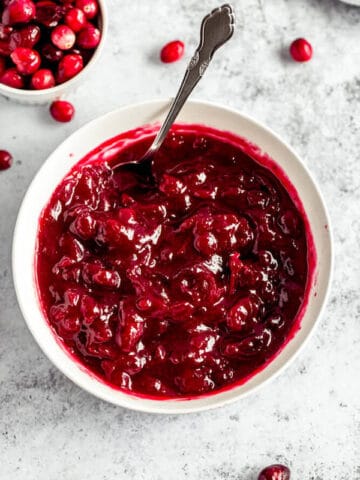 homemade cranberry sauce in a bowl with a spoon