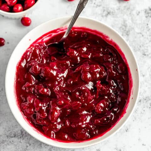 homemade cranberry sauce in a bowl with a spoon