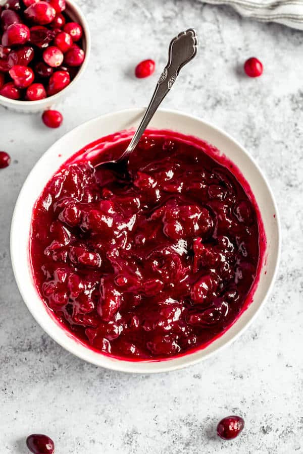 homemade cranberry sauce in a bowl with a spoon