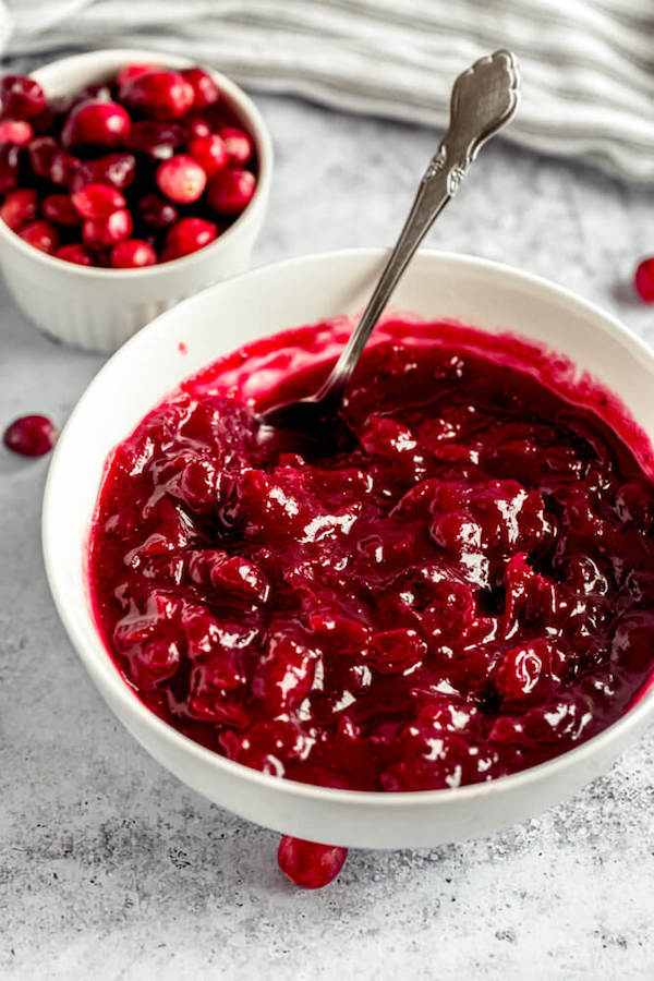 homemade cranberry sauce in a bowl with a spoon