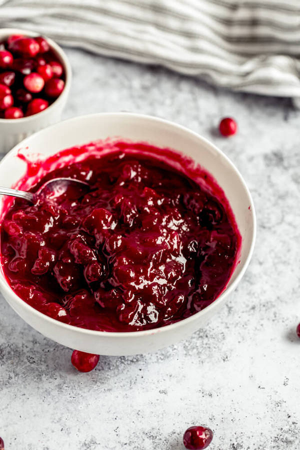 homemade cranberry sauce in a bowl with a spoon