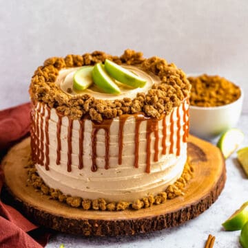 caramel apple crumble cake on a wooden cake stand