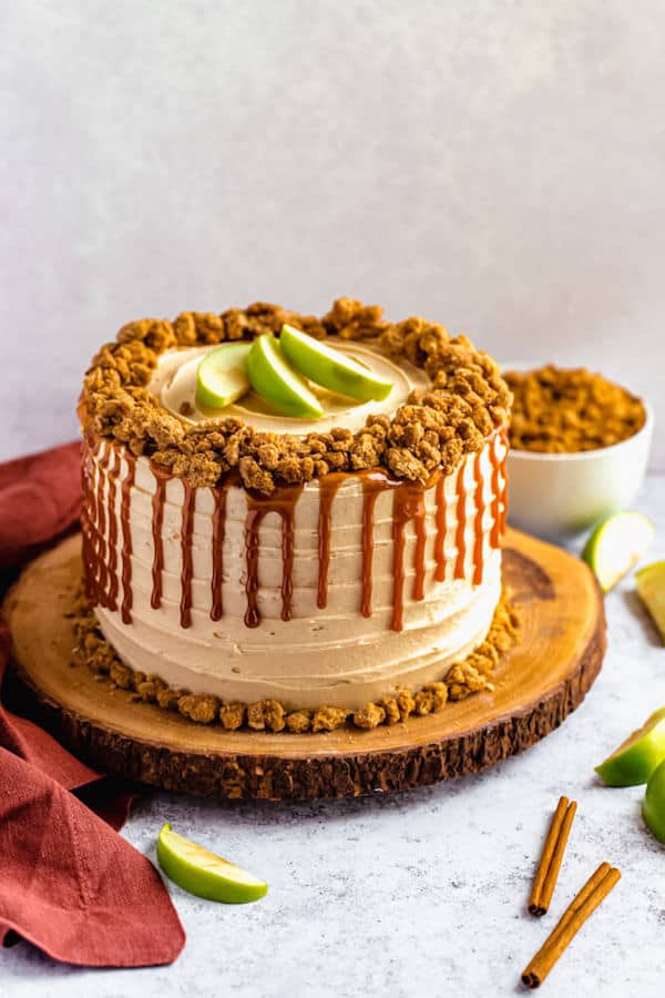 caramel apple crumble cake on a wooden cake stand