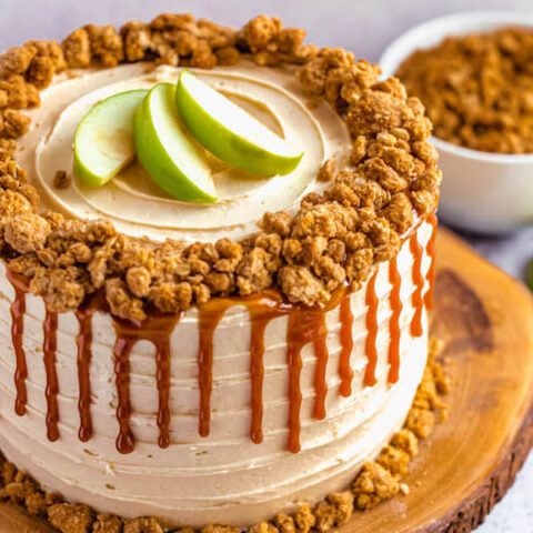 caramel apple crumble cake on a wooden cake stand
