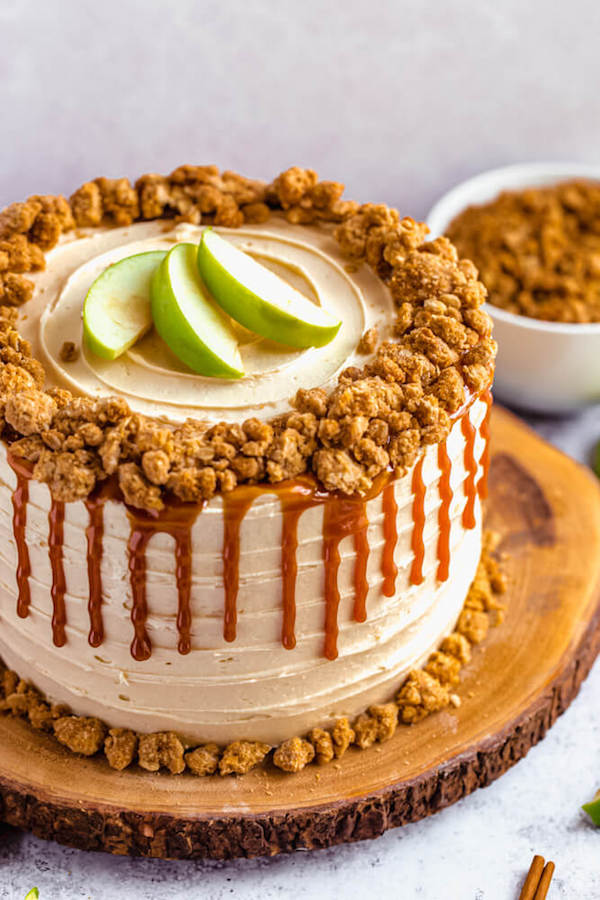 caramel apple crumble cake on a wooden cake stand