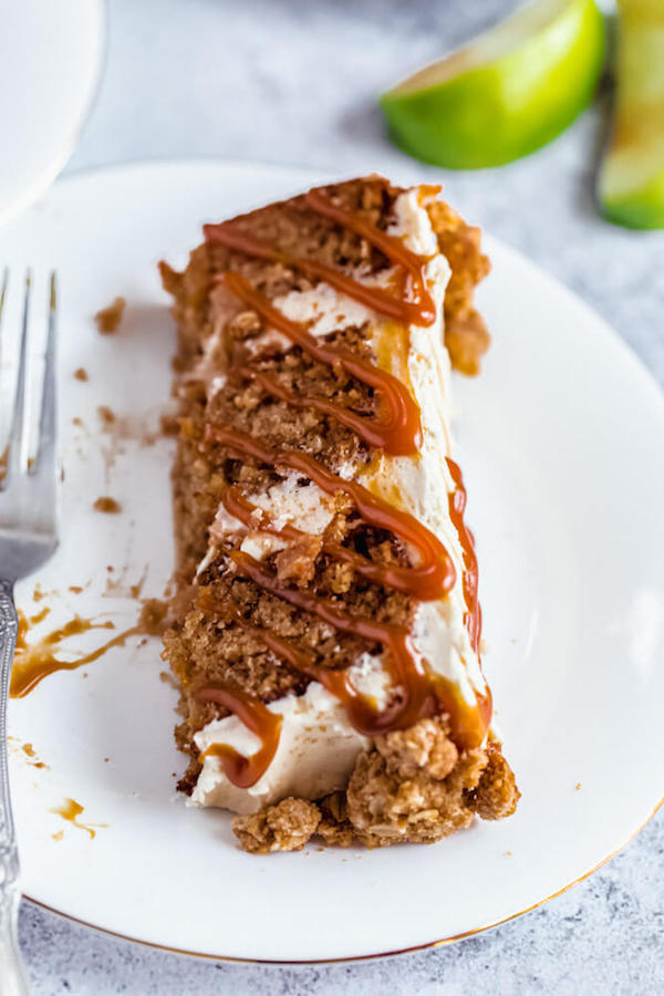 half eaten slice of caramel apple crumble cake on a plate