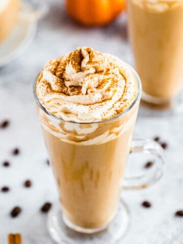 homemade pumpkin spice latte topped with whipped cream and a dust of cinnamon