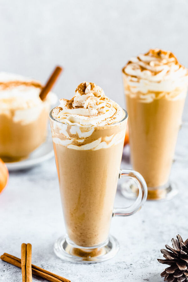 homemade pumpkin spice latte topped with whipped cream and a dust of cinnamon