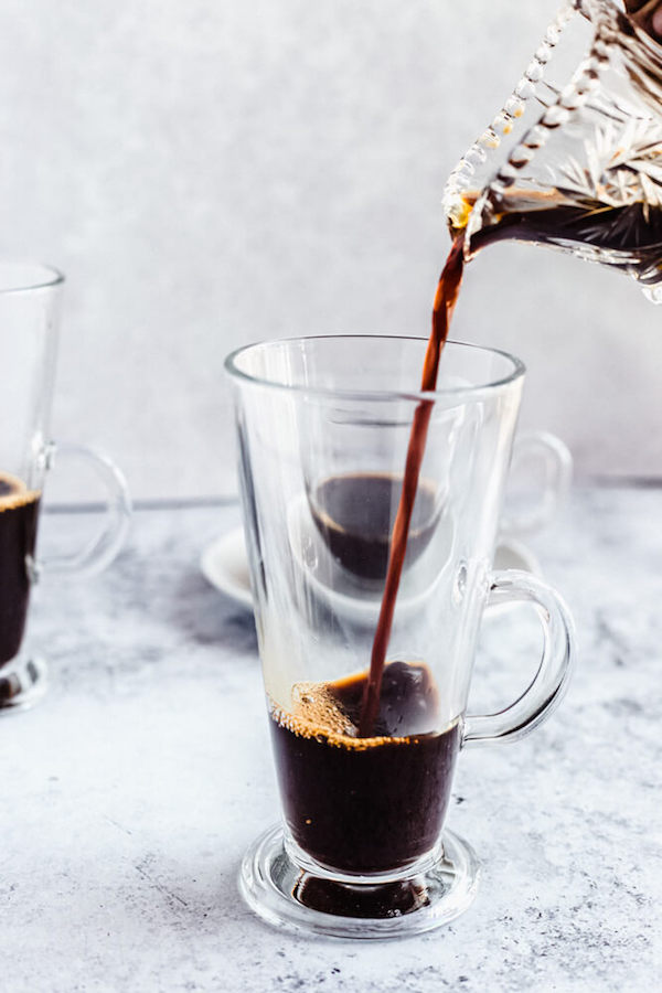 pouring espresso into glass