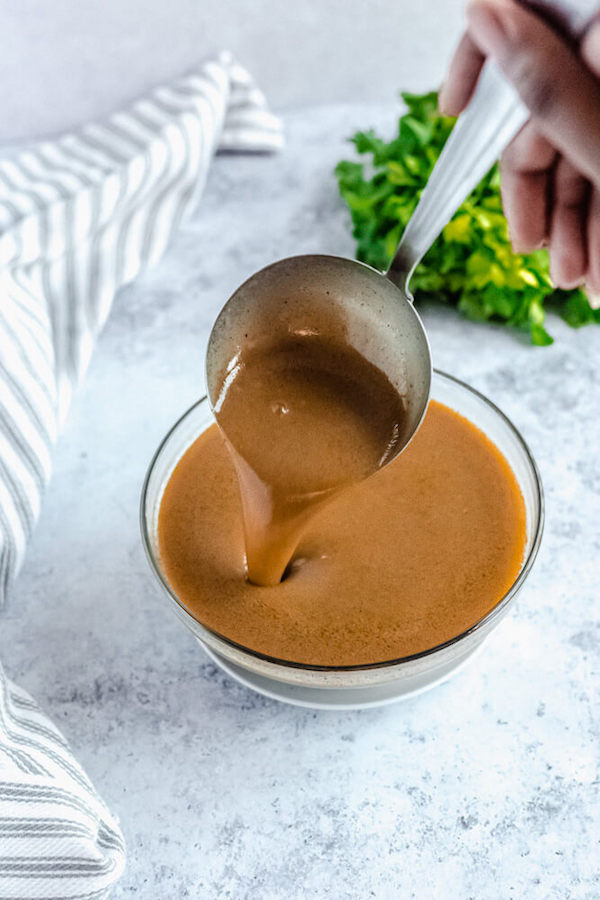 pouring gravy back into bowl with ladle