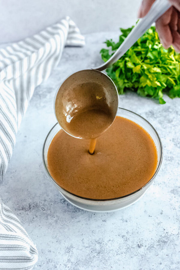 pouring gravy back into bowl with ladle