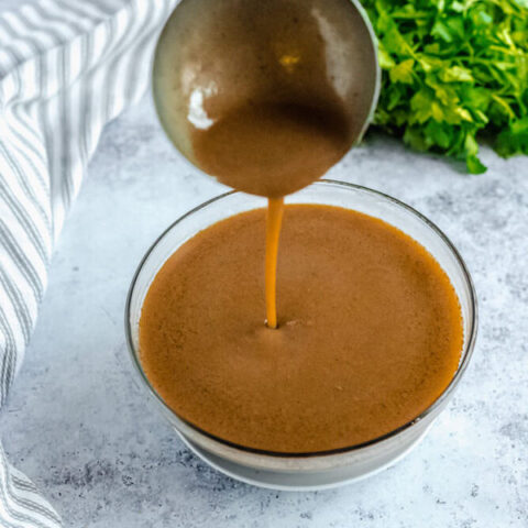 pouring gravy back into bowl with ladle