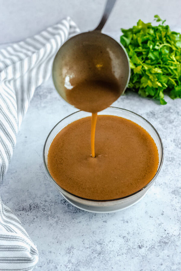 pouring gravy back into bowl with ladle