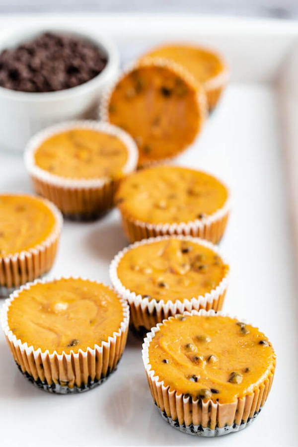 undecorated pumpkin cheesecakes on a white tray