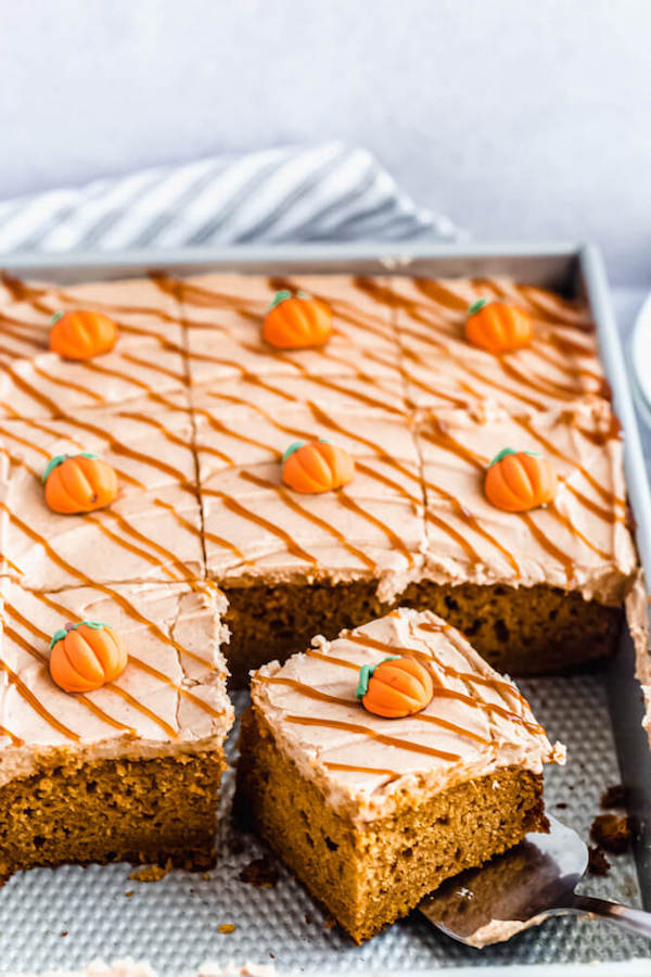 pumpkin cake topped with cream cheese frosting in a rectangle cake pan
