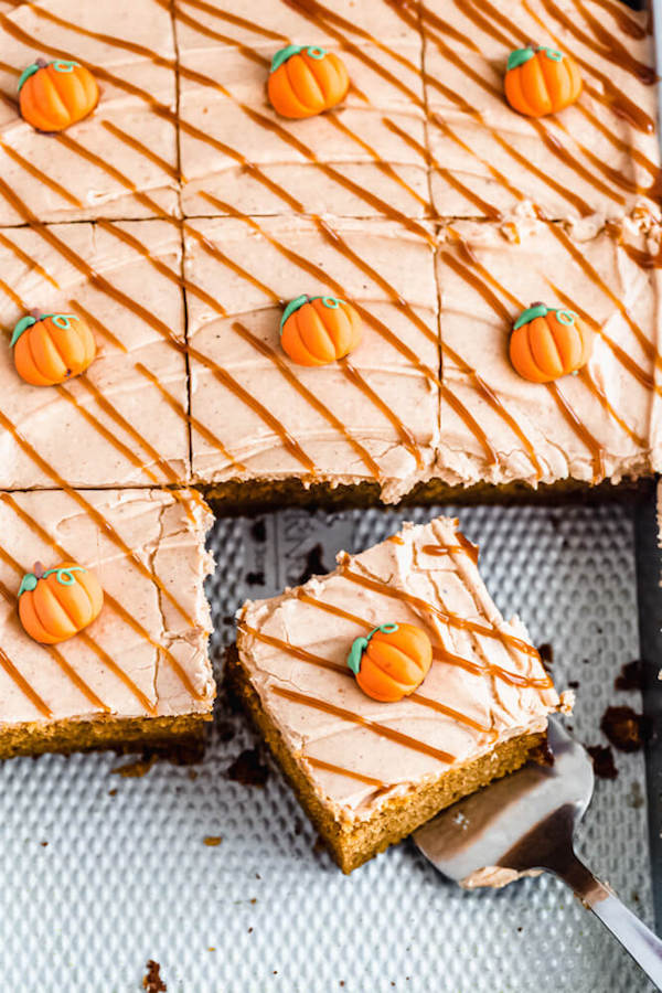 pumpkin cake topped with cream cheese frosting in a rectangle cake pan