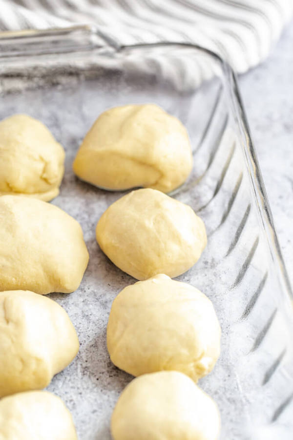 unbaked dinner rolls in a baking dish