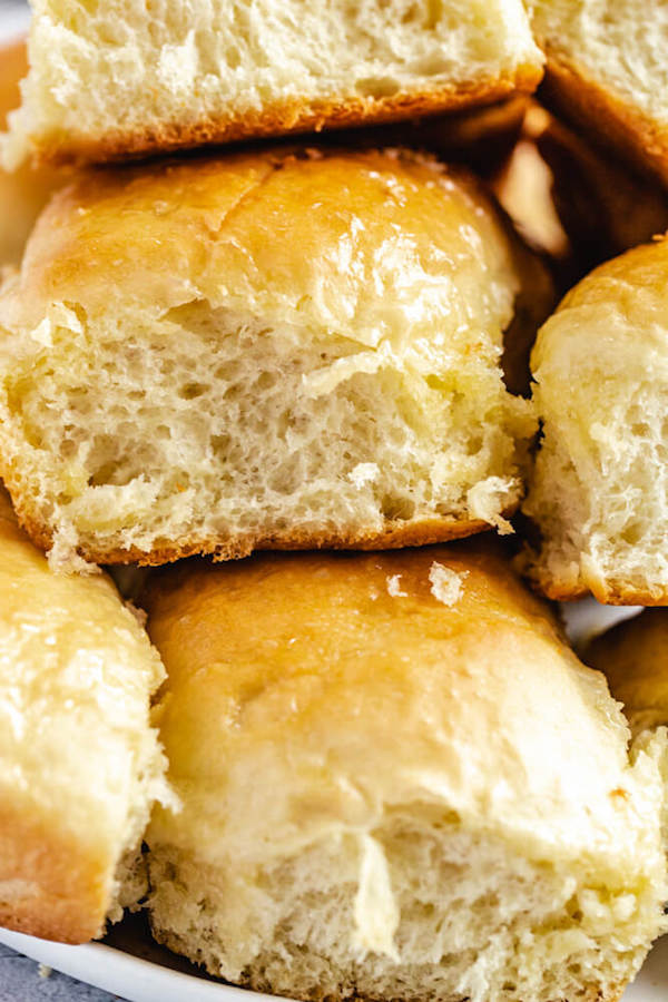 close up of dinner rolls stacked on a plate