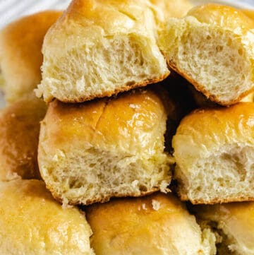 dinner rolls stacked on a plate